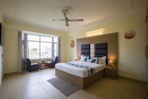 a bedroom with a large bed and a window at The Walnut Stays in Solan