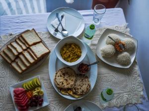 a table with plates of food on a table at Difference Rajarata Hotel in Anuradhapura +14 photos