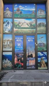 a building with a bunch of windows with different cities at Hotel International in Yerevan