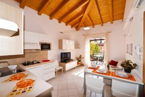 a kitchen with white cabinets and a counter top at Villaggio Sant'Andrea in Caorle