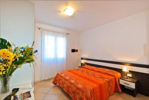 Ένα ή περισσότερα κρεβάτια σε δωμάτιο στο Villaggio Sant'Andrea