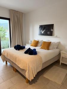 a bedroom with a large bed with blue towels on it at Trebol in Sa Pobla