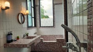 a bathroom with a brick sink and a window at Kelly Field Homestay in Guangfu +47 photos