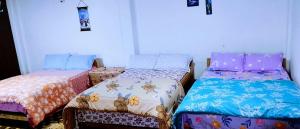 a room with two beds in a room at Lama homestay in Darjeeling