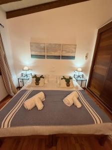 a bedroom with a large bed with two pillows at Nispero in Sa Pobla