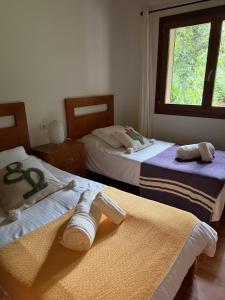 a bedroom with two beds with towels on them at Nispero in Sa Pobla