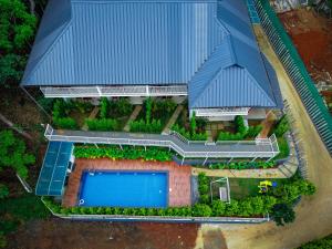 an overhead view of a house with a swimming pool at Ice Cloud Munnar Pool Resort in Munnar +18 photos