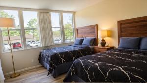 a bedroom with two beds and a window at Santa Monica Executive Suites in Los Angeles