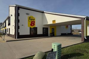 a gas station with a sign in front of it at Super 8 by Wyndham Lincoln in Lincoln