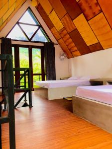 a room with two beds and a large window at Riverston Grand Villas in Meda-Ela +58 photos