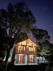 a house with a tree in front of it at night at Riverston Grand Villas in Meda-Ela