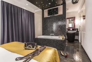 łazienka z łóżkiem, wanną i umywalką w obiekcie JC Hotel w Rzymie