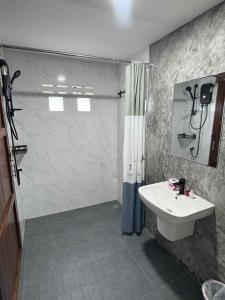 a bathroom with a shower and a sink at Stay at Lanta Bungalow in Ko Lanta