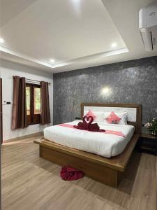 a bedroom with a large bed with a bow on it at Stay at Lanta Bungalow in Ko Lanta