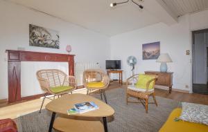 a living room with chairs and a table at 3 Bedroom Awesome Apartment In Olmeto in Olmeto