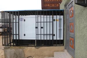 a gate with two doors on the side of a building at Folks Apartment in Mama +15 photos