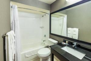 a bathroom with a white toilet and a sink at Comfort Inn Truro in Truro +33 photos