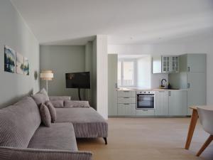 a living room with a couch and a kitchen at LIMIX Stays in Appiano sulla Strada del Vino