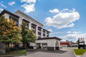 a building with a gas station in front of it at Hotel Quartier, an Ascend Collection Hotel in Quebec City