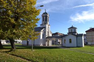 a large white church with a clock tower at Cute and Cozy in Pale