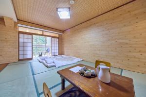 a room with a table and a bed in a room at 日光いろは in Nikko