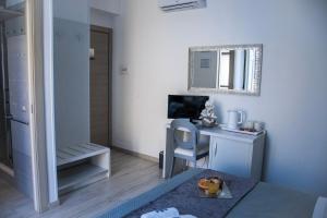 a room with a desk with a computer and a mirror at B&B PLAZA in Lampedusa