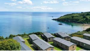 an aerial view of a row of houses next to the ocean at Lodge 66 at Riviera Bay Coastal Retreat in Brixham