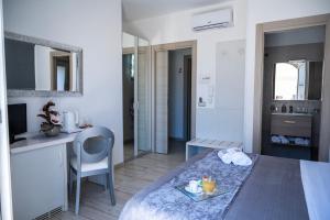 a room with a bed and a desk and a kitchen at B&B PLAZA in Lampedusa +66 photos
