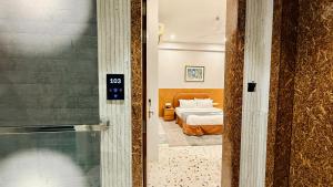 a door leading to a bedroom with a bed at Hotel Citadel Inn in Indore +132 photos