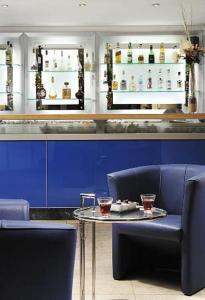 a bar with a table and two chairs and drinks at Relax Hotel Acquaviva - Tuscany Hills in Lucciana