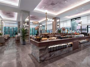 a restaurant with a buffet line with food on display at Mercure Chengdu Shuangliu in Chengdu