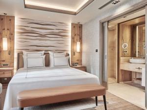a bedroom with a large bed and a bathroom at Swissotel Uludag Bursa in Bursa