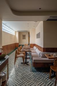 a row of tables and chairs in a restaurant at Abode Jaipur in Jaipur