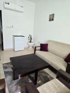 a living room with a couch and a coffee table at Mozna Hostel in Muscat