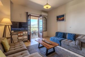 a living room with a couch and a table at Vardia Hotel in Kardamili