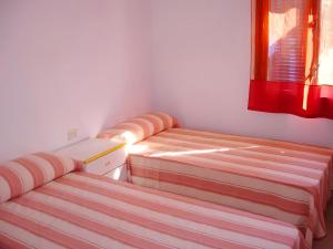a room with two beds and a window at Villa del Pi in L'Ametlla de Mar +24 photos