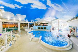 a large pool in a building with people in it at Hakone Forest of Verde in Hakone