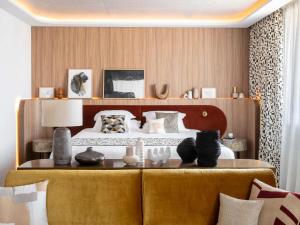 a bedroom with a large bed and a couch at Pullman Lyon in Lyon