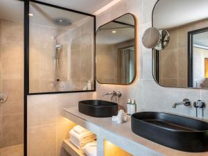 a bathroom with a black sink and a mirror at Pullman Lyon in Lyon +99 photos