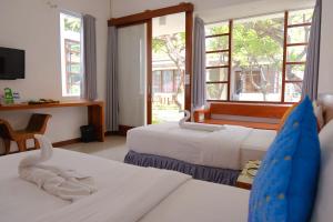 a hotel room with two beds and a window at Alba Tulamben in Tulamben +75 photos