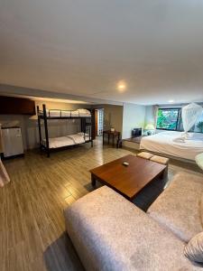 a living room with two beds and a couch at Pridi cozy home with good location Type A in Bangkok