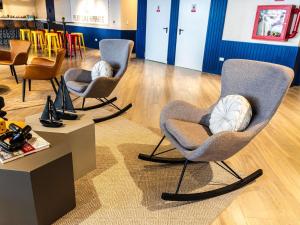 a group of chairs sitting in a room at Ibis Styles El Malecon Guayaquil in Guayaquil +171 photos