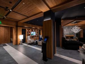 a living room with wood paneling and a living room with a couch at Swissôtel Resort Kolasin in Kolašin