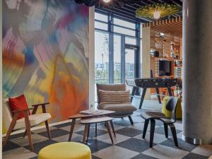 a room with chairs and a table and a piano at Aparthotel Adagio Heidelberg in Heidelberg
