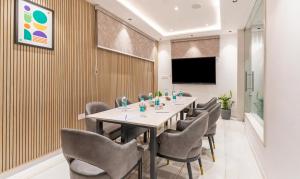 a conference room with a long table and chairs at Treebo Liyan Orchid, Hsr Layout in Bangalore