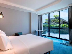 Giường trong phòng chung tại Novotel Yogyakarta International Airport Kulon Progo