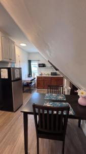 a living room with a table and a kitchen at Loft Private Studio -- Washer and Dryer -- Near Boston Transit in Malden