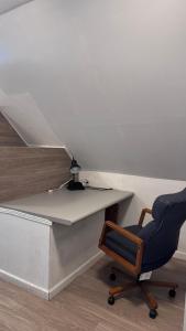 a desk and a chair next to a staircase at Loft Private Studio -- Washer and Dryer -- Near Boston Transit in Malden