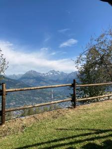 a wooden fence with a view of the mountains at Appartamento Blu - Cerise in Cerise