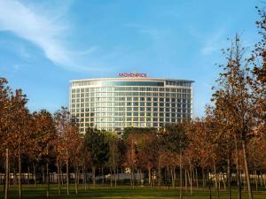 a large building with a sign on top of it at Mövenpick Hotel Istanbul Marmara Sea in Istanbul